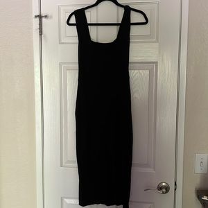 Black Cassi knit dress by reformation dress with a slit on the left side.
